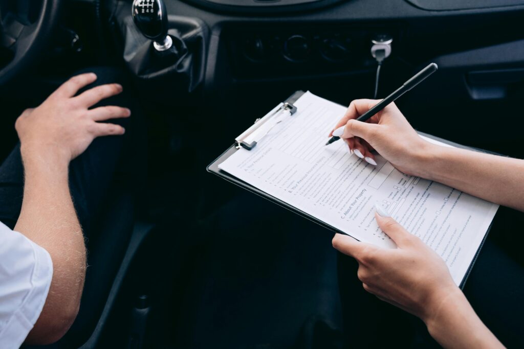 Person Writing on a Clipboard conducting inspection inside the Vehicle